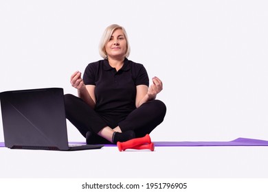 Middle Aged Senior 50s Woman Learning Meditate At Home Watching Live Online Tv Yoga Class Tutorial On Website Looking At Laptop Pc Doing Virtual Training Fitness Workout Exercises. High Quality Photo