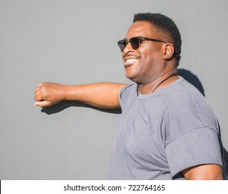 Middle Aged Smiling Black Man Knocking On Door Outside