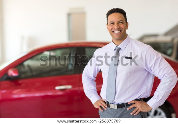 middle aged\
vehicle sales consultant inside\
showroom