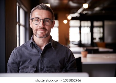 Middle Aged White Male Creative Sitting In An Office Smiling To Camera, Head And Shoulders, Close Up