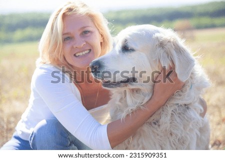 Similar – Pretty blond woman with her two dogs