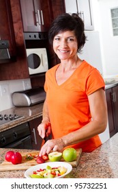 Middle Aged Woman Cooking In Kitchen