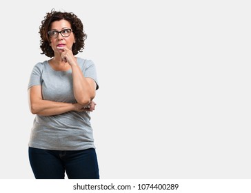 Middle Aged Woman Doubting And Confused, Thinking Of An Idea Or Worried About Something