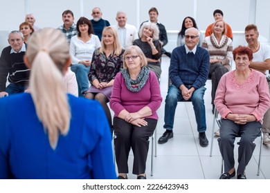 Middle aged woman executive manager company representative welcoming business partner while sitting in modern office boardroom or trainer - Powered by Shutterstock