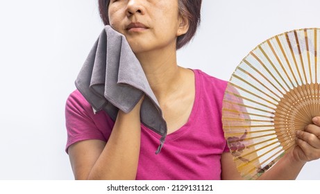 Middle aged woman feel hot flashes or overheated , symptoms of menopause - Shutterstock ID 2129131121