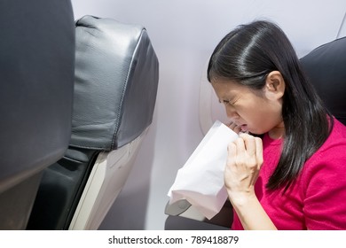 middle aged woman feel vomit  in the airplane