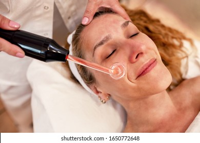 Middle Aged Woman Having A High Frequency Facial Cosmetic Treatment, Skin Treatment Concept