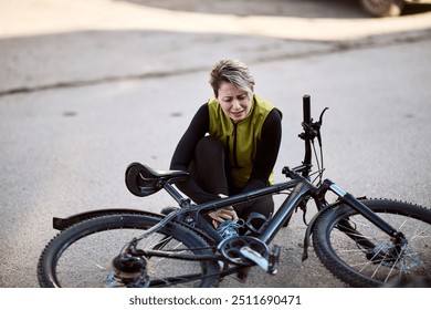 A middle aged woman having injury while cycling on the city street. - Powered by Shutterstock