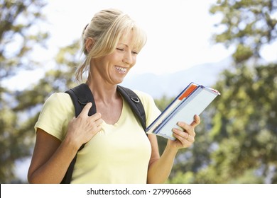 Middle Aged Woman Hiking Through Countryside