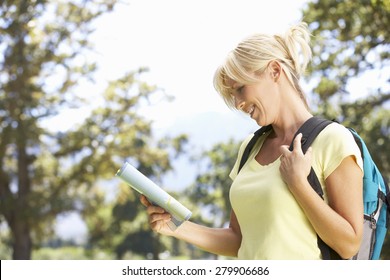 Middle Aged Woman Hiking Through Countryside