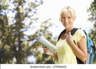 Middle Aged Woman Hiking Through Countryside