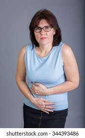 Middle Aged Woman Holding Her Aching Stomach