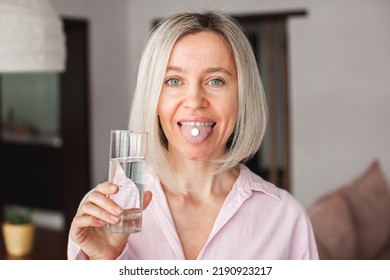 Middle Aged Woman Holding Pill And Glass Of Fresh Water, Taking Medicine From Headache, Stomach Pain Or Taking Vitamins, Sedation Meds, Healthcare Concept