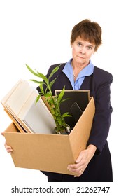 Middle Aged Woman Laid Off From Her White Collar Job Carries A Box Of Her Belongings.  Isolated On White.