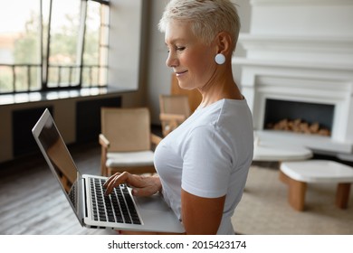 Middle Aged Woman Learning How To Use Modern Device. Cute Mature Lady Press Buttons On Laptop. Keep Up With Developments, Modern Innovations, New Skill, Explore Technology Concept