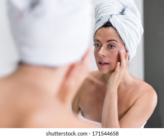 Middle Aged Woman Looking At Herself In The Mirror