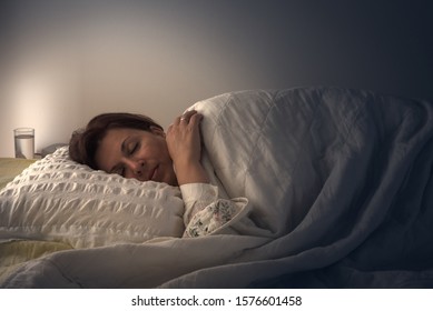 Middle Aged Woman Lying In Bed