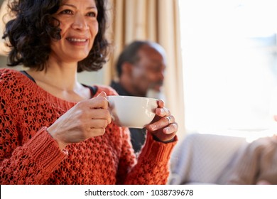 Middle Aged Woman Meeting Friends Around Table In Coffee Shop