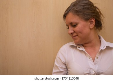 Middle Aged Woman Portrait. Caucasian 40 Years Woman Not Looking At Camera And Smiling. White Business Shirt Is Dressed. Calm Face And Positive Emotions. Background With Copy Space