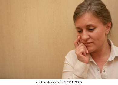 Middle Aged Woman Portrait Touching Her Face With Hand. 40 Years Woman Not Looking At Camera. White Business Shirt Is Dressed. Thinking Face And Calm Emotions