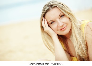 Middle Aged Woman Resting At Beach Near The Sea