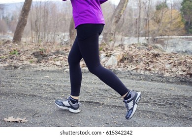 Middle Aged Woman Running In Forest