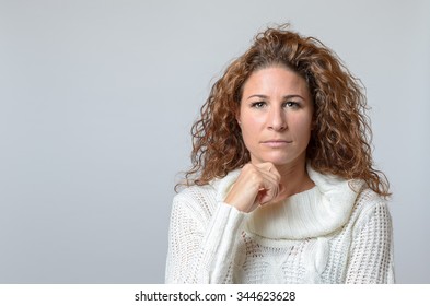 Middle Aged Woman With A Serious Expression Halding On Hand To Her Chin