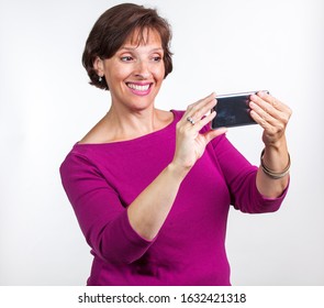 Middle Aged Woman Taking A Selfie. Gen X Social Media Concept Image