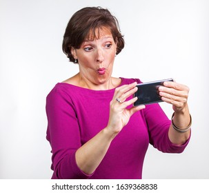 Middle Aged Woman Taking A Selfie. Gen X Social Media Concept Image