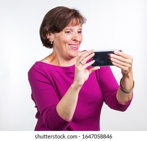 Middle Aged Woman Taking A Selfie. Gen X Social Media Concept Image