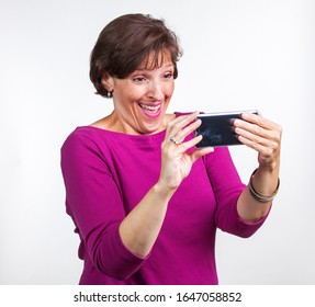 Middle Aged Woman Taking A Selfie. Gen X Social Media Concept Image