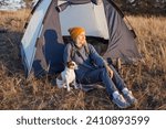 Middle aged woman travel and camping alone at fall forest. Recreation and journey outdoor activity lifestyle