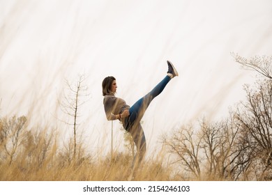 Middle Aged Woman Working Out With Her Legs In Nature