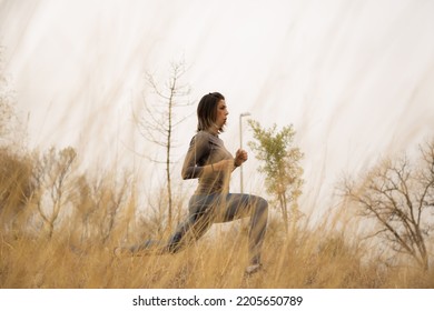 Middle Aged Woman Working Out In The Meadow