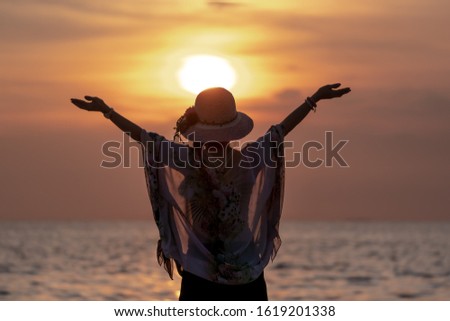 Middle Aged Women Hapy Lift their Arms out while on Sunset  at Beach.