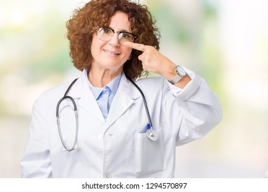 Middle Ager Senior Doctor Woman Over Isolated Background Pointing With Hand Finger To Face And Nose, Smiling Cheerful