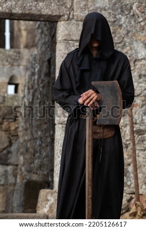 Middle Ages Executioner with a rusty iron Axe, Santa Maria da Feira, Portugal.