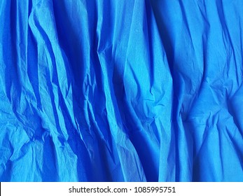 middle blue wrinkled paper background satin blank texture, creased surface. for web and print