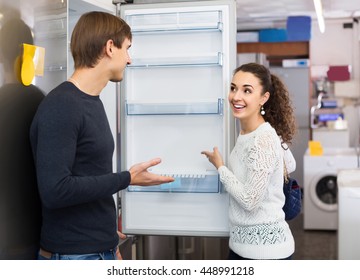 Middle Class European Family Couple Choosing New Refrigerator In Hypermarket 