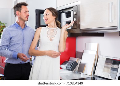 Middle Class Married Couple Selecting Modern Kitchen Furniture  