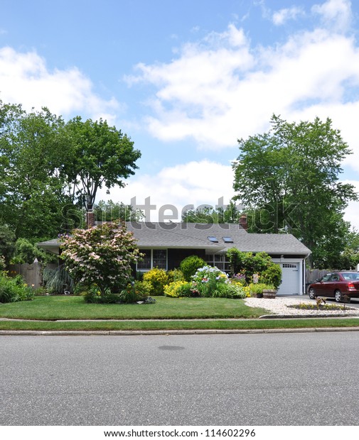 Middle Class Suburban Home with Flowers Plant\
Life on landscaped front yard\
lawn
