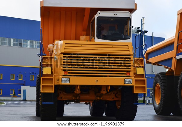 The middle class\
yellow mining dump truck for work on transportation of sand and\
minerals in mines. close-up