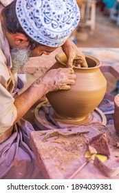 Middle East, Arabian Peninsula, Oman, Ad Dakhiliyah, Bahla. Oct. 23, 2019. Man working at a potter's wheel at the Aladawi pottery factory in Oman.