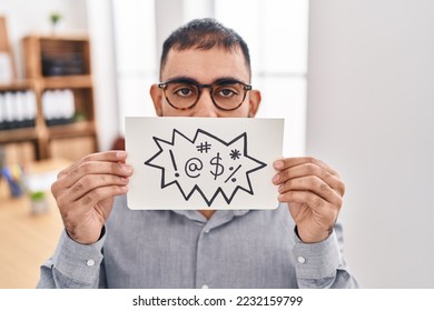 Middle east man with beard holding banner with swear words relaxed with serious expression on face. simple and natural looking at the camera.  - Shutterstock ID 2232159799