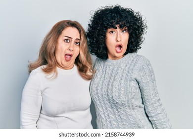 Middle East Mother And Daughter Wearing Casual Clothes In Shock Face, Looking Skeptical And Sarcastic, Surprised With Open Mouth 