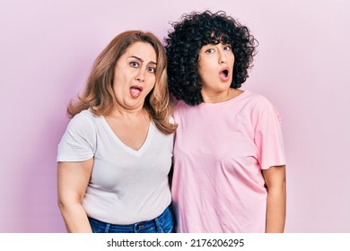 Middle East Mother And Daughter Wearing Casual Clothes In Shock Face, Looking Skeptical And Sarcastic, Surprised With Open Mouth 