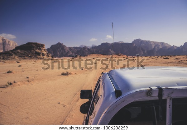 Middle East tourism photography\
of car tour in Jordan desert scenic landscape background\
view