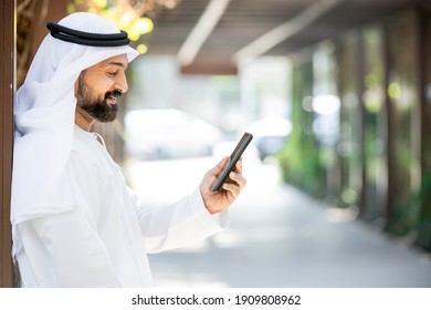 Middle Eastern Arab Emirati man using mobile phone