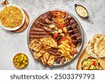 Middle Eastern or Arabic cuisine with a variety of mezze on a rustic concrete backdrop Food that is Halal. Cuisine from Lebanon, Turkey, and Egypt, with mixed veggies and a gorgeous table top view
