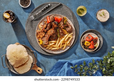 Middle Eastern or Arabic cuisine with a variety of mezze on a rustic concrete backdrop Food that is Halal. Cuisine from Lebanon, Turkey, and Egypt, with mixed veggies and a gorgeous table top view